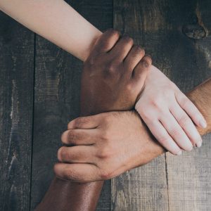 Three hands linked together