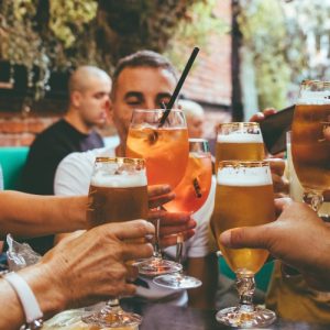 people raising their drinks in cheers