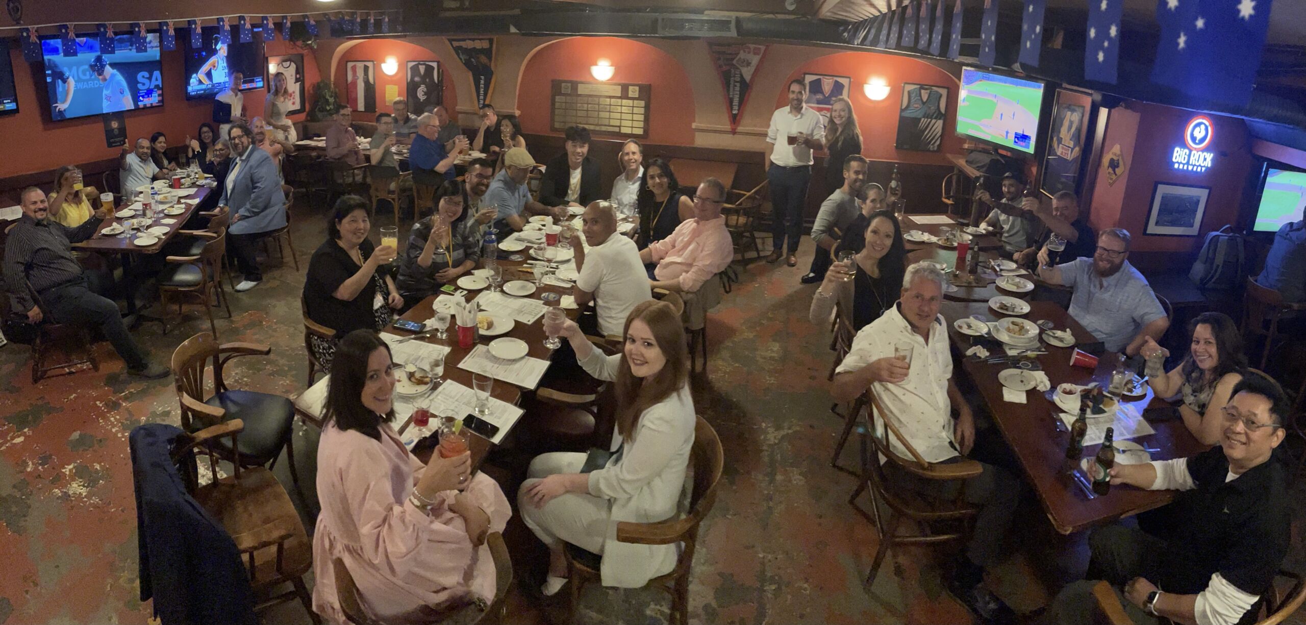 A group of people gathered at a networking mixer in a pub.